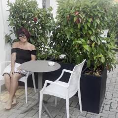 Showing tits outdoors and undressing in front of glass french door