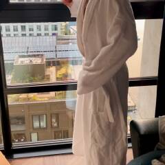 Petite milf showing sweet body in front of hotel window